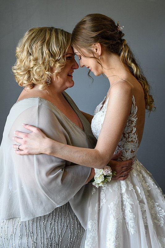 Bride and mother embrace